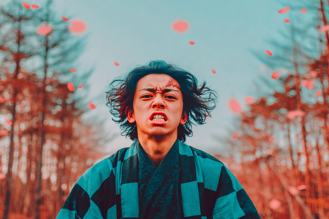 Tanjiro Kamado in a manga-style forest with dynamic lighting and cherry blossom petals  