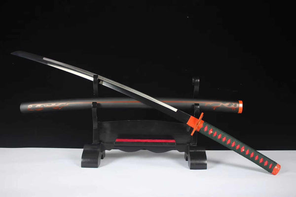 Shinobu Kocho katana replica partially drawn on stand — dark steel blade with hamon, orange and green butterfly tsuba, green cotton ito handle with red underlayer, orange fittings, black saya with orange butterfly designs
