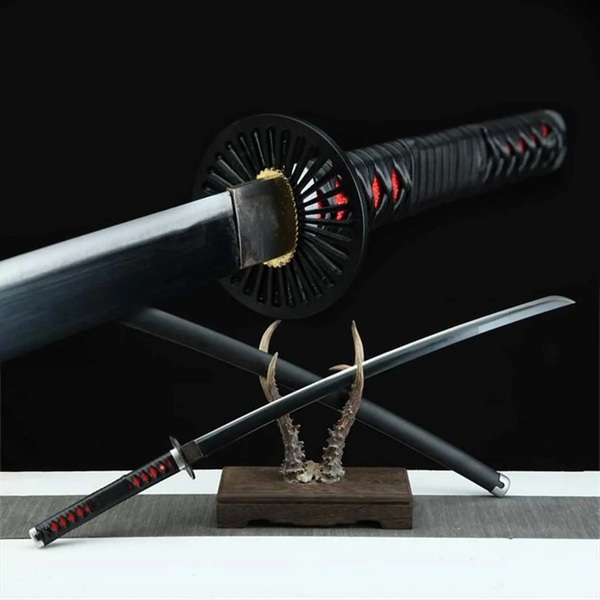Tanjiro Kamado Demon Slayer katana replica — black ito wrap, red rayskin, sunburst tsuba on antler stand